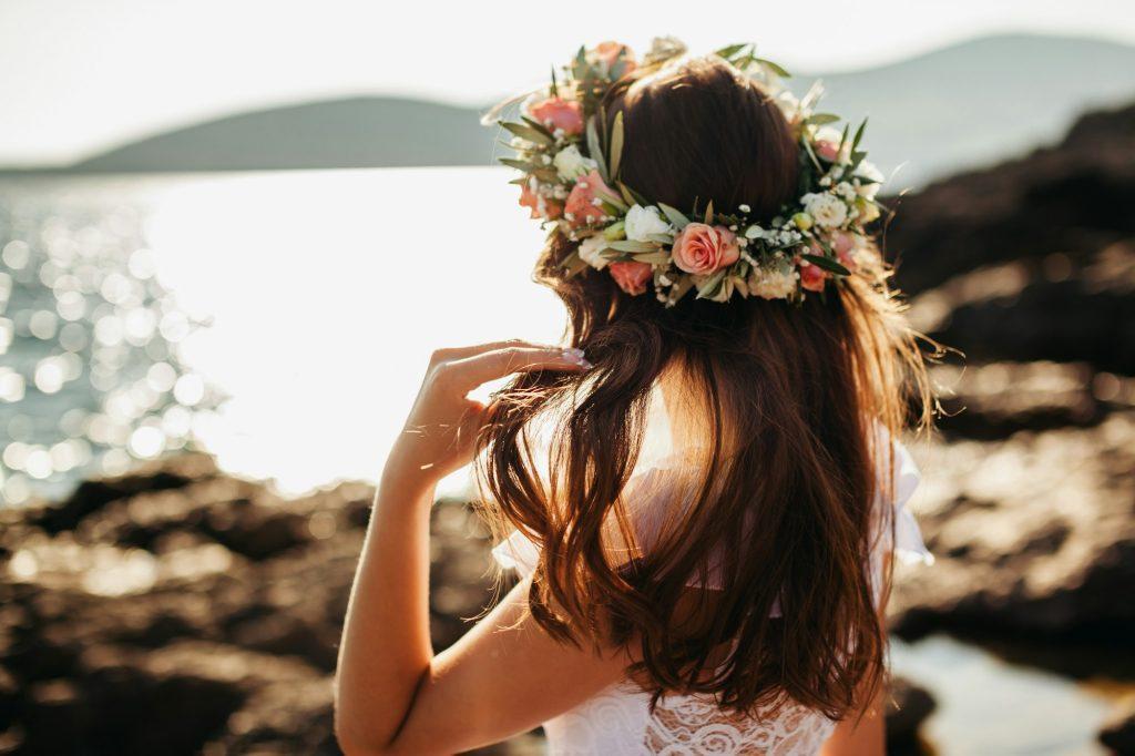 woman in bridal wreath on beach